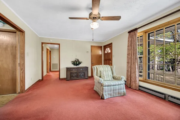 a living room with furniture and a floor to ceiling window