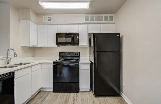 a kitchen with a sink stainless steel appliances and cabinets
