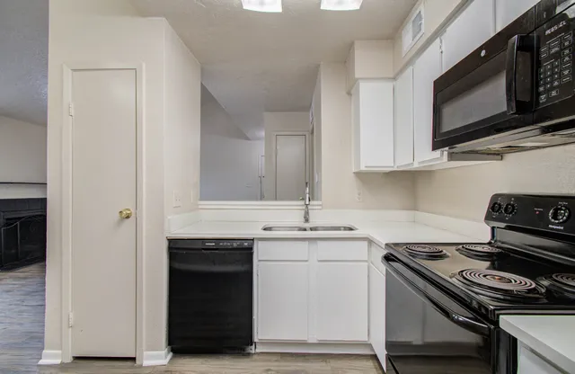 a kitchen with stainless steel appliances granite countertop a stove and a microwave