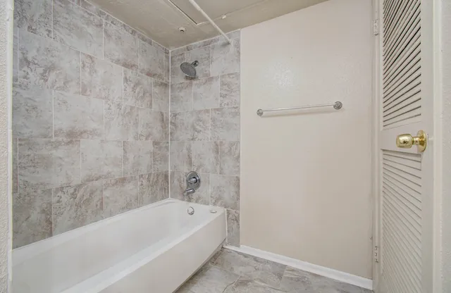 a bathroom with a bathtub and shower