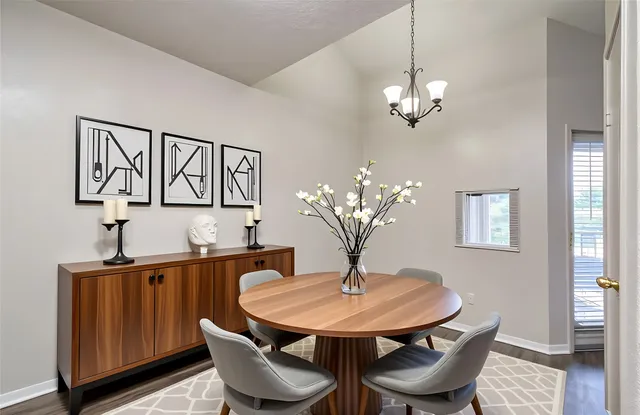 a view of a dining room with furniture and wooden floor