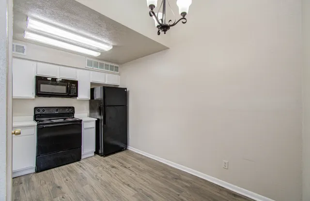 a kitchen with stainless steel appliances a refrigerator and a stove top oven