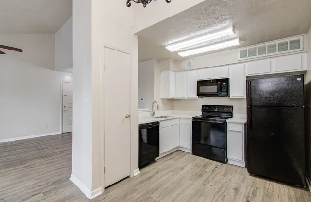 a kitchen with a refrigerator stove and microwave