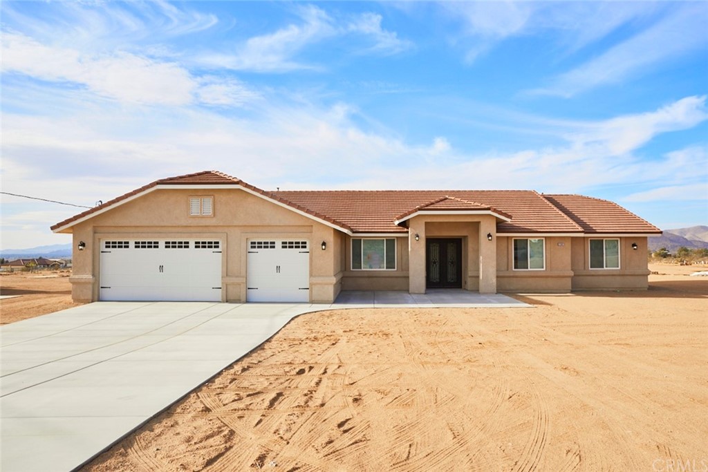 23362 Tussing Ranch Road Apple Valley, CA 92308 - Photo 1 of 1 a front view of a house with a yard