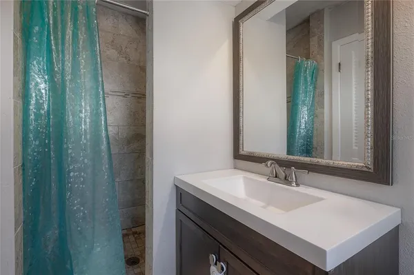 a bathroom with a sink a toilet and mirror