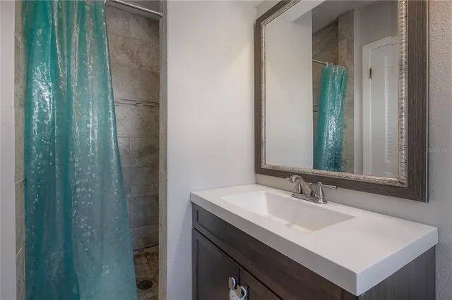 a bathroom with a sink a toilet and mirror
