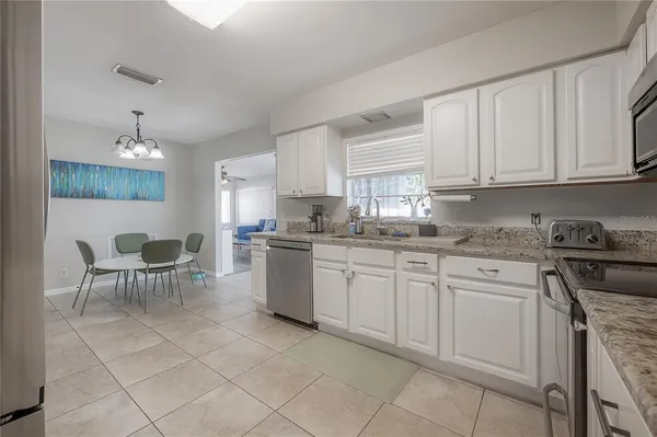 a kitchen with cabinets and chairs