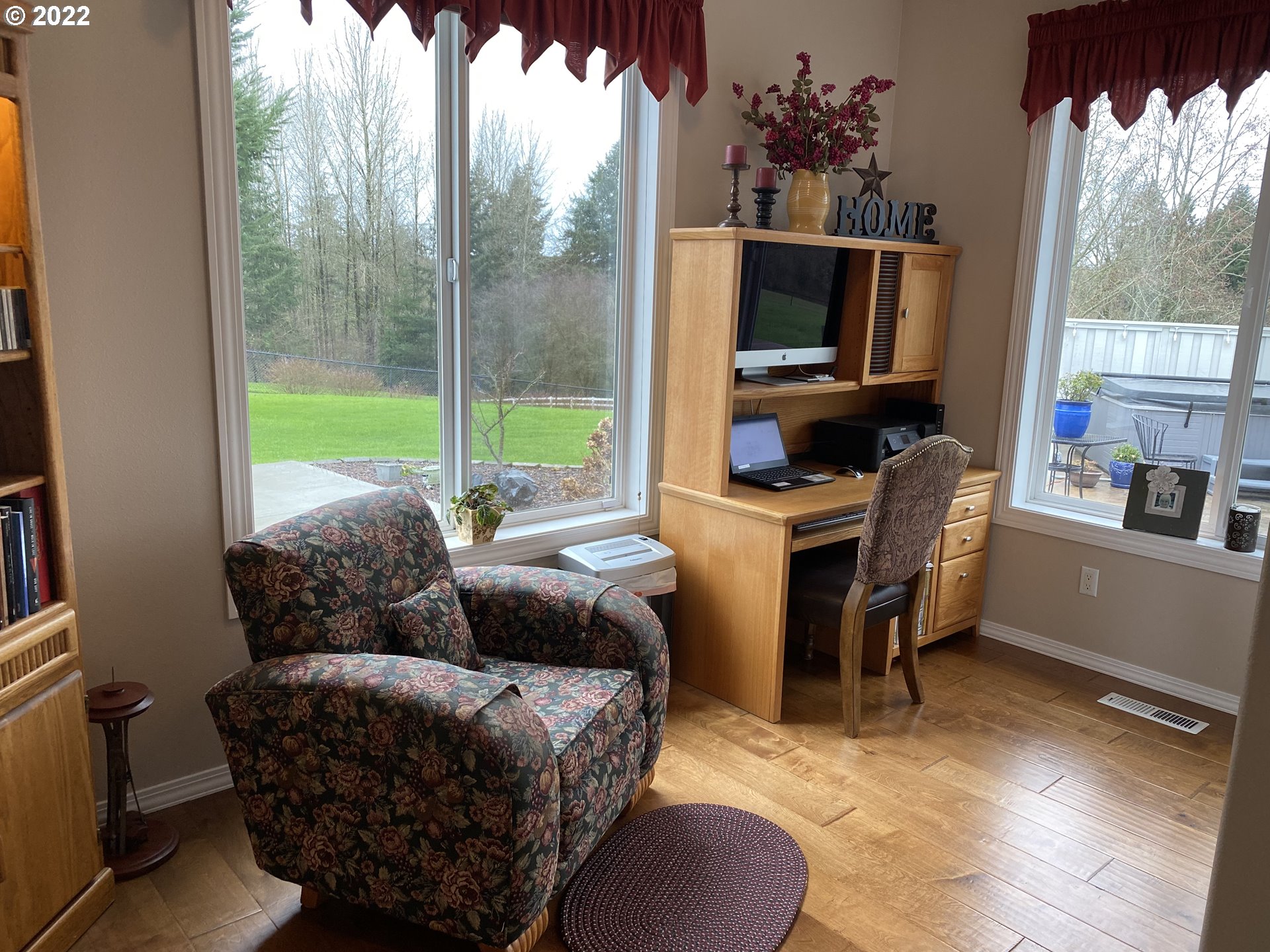 5606 Northwest 280th Street Ridgefield, WA 98642 - Photo 12 of 32 a living room with furniture a flat screen tv and a floor to ceiling window