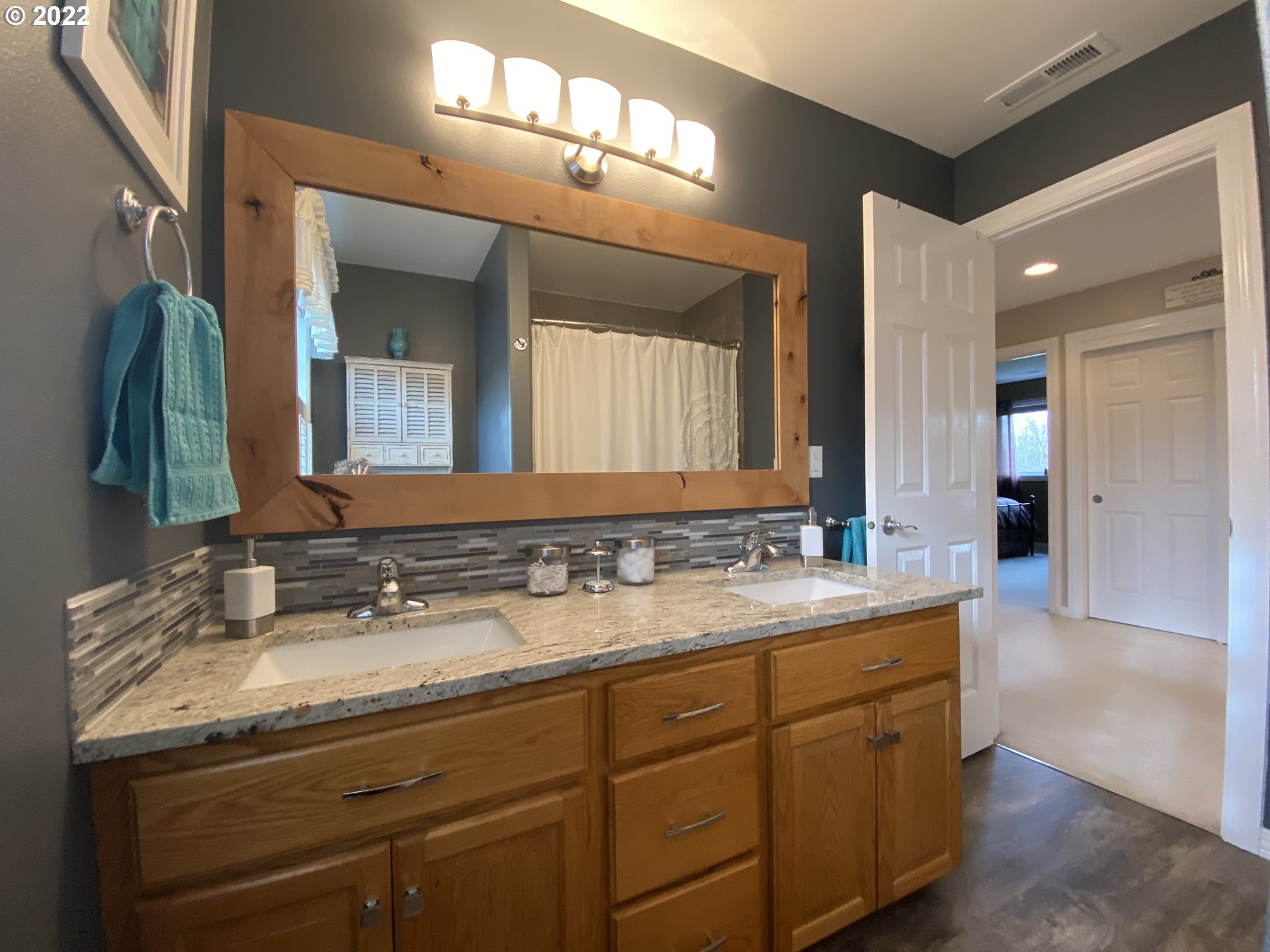 5606 Northwest 280th Street Ridgefield, WA 98642 - Photo 17 of 32 a bathroom with a sink and a mirror