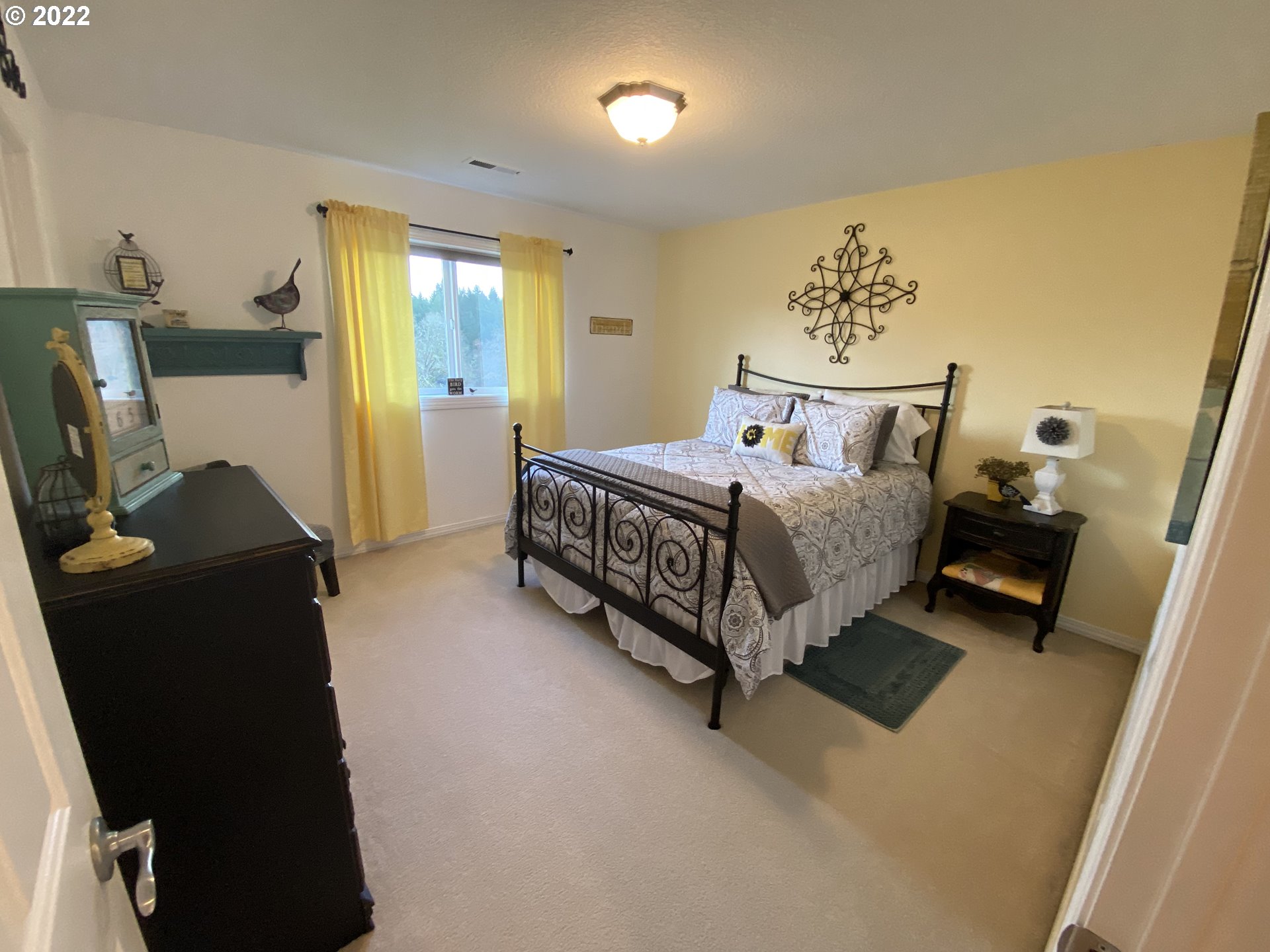 5606 Northwest 280th Street Ridgefield, WA 98642 - Photo 19 of 32 a spacious bedroom with a bed and a window