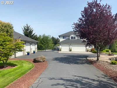 5606 Northwest 280th Street Ridgefield, WA 98642 - Photo 2 of 32 a front view of a house with a yard and a garage