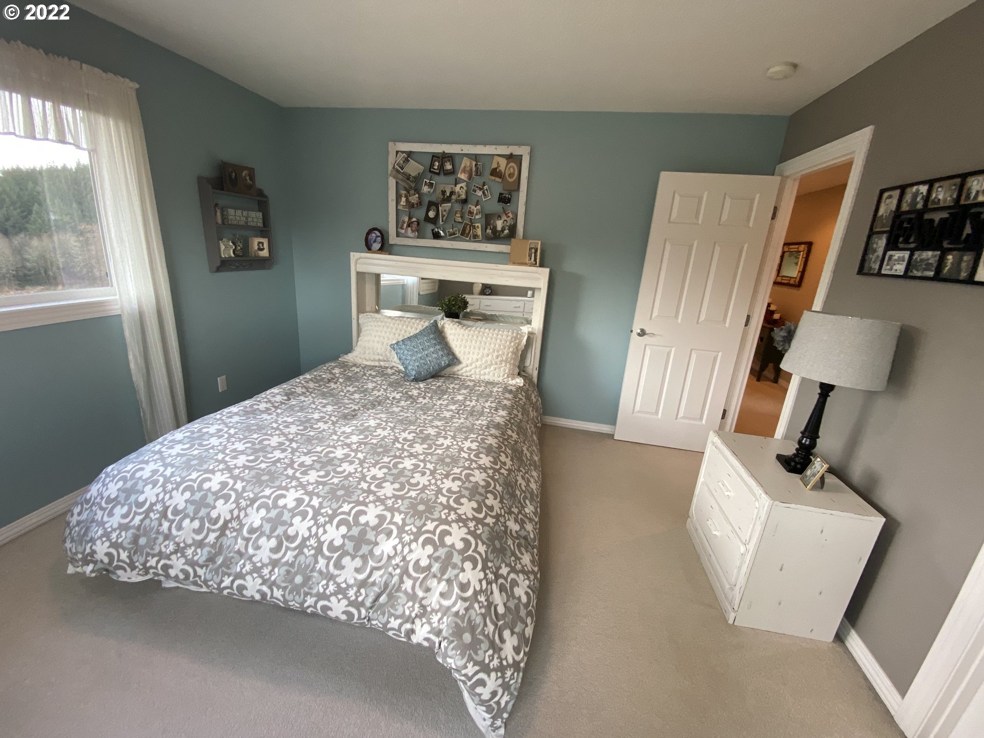5606 Northwest 280th Street Ridgefield, WA 98642 - Photo 21 of 32 a large bed sitting in a bedroom next to a window