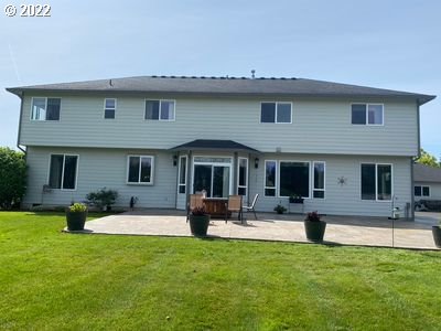 5606 Northwest 280th Street Ridgefield, WA 98642 - Photo 26 of 32 a front view of house with outdoor seating and yard