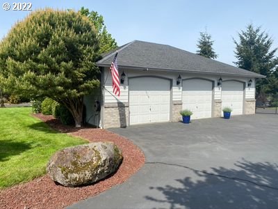 5606 Northwest 280th Street Ridgefield, WA 98642 - Photo 4 of 32 a front view of a house with a yard and garage