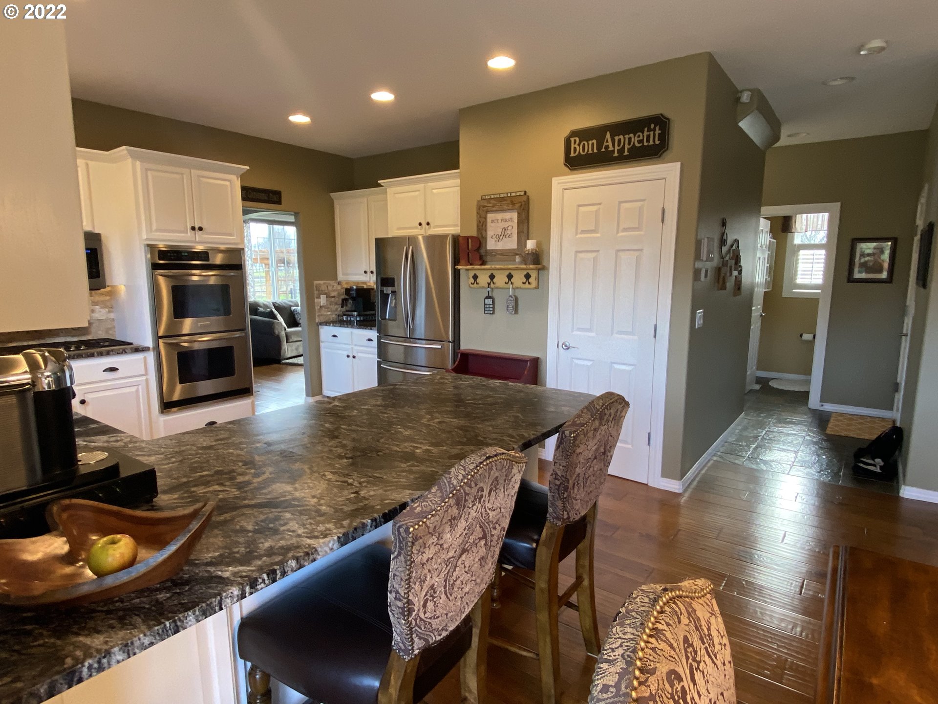 5606 Northwest 280th Street Ridgefield, WA 98642 - Photo 7 of 32 a kitchen with stainless steel appliances granite countertop a stove refrigerator and cabinets