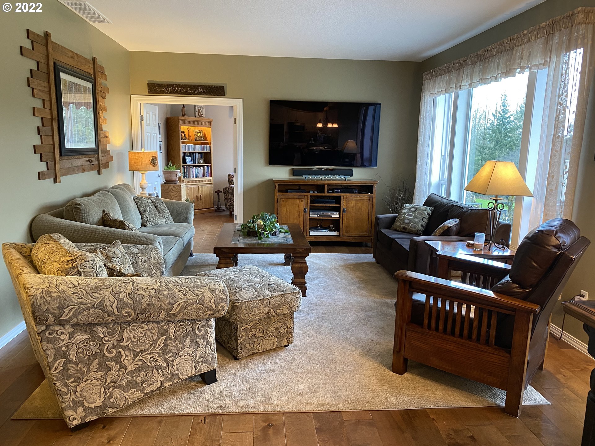 5606 Northwest 280th Street Ridgefield, WA 98642 - Photo 9 of 32 a living room with furniture a flat screen tv and a large window