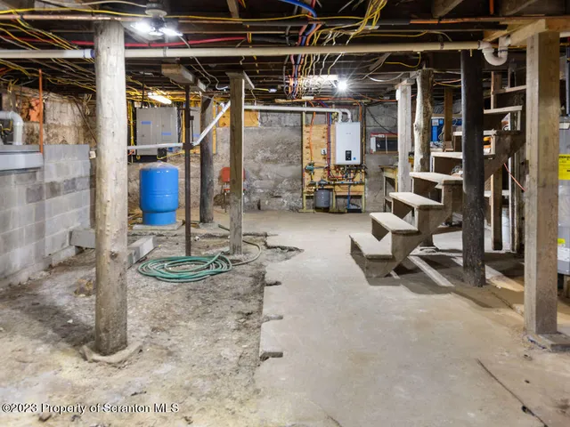 a view of a room with wooden floor and windows