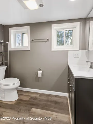 a bathroom with a shower a toilet and a sink