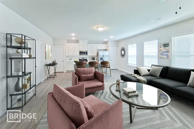 a living room with furniture a large window and a table