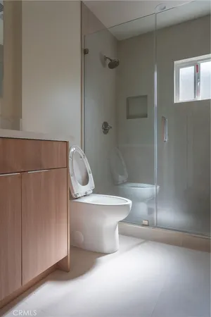a white toilet sitting next to a bathroom sink