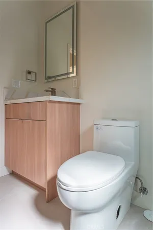 a white toilet sitting next to a bathroom sink