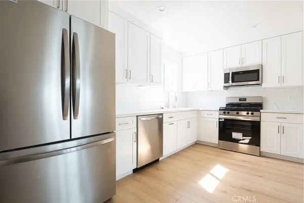 a kitchen with a refrigerator stove and microwave