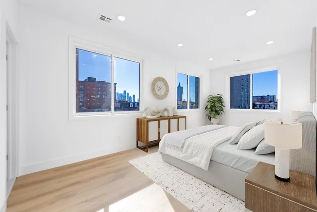 a bedroom with a large bed and a wooden floor