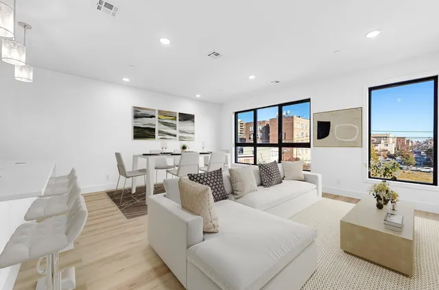 a living room with furniture wooden floor and a view of kitchen
