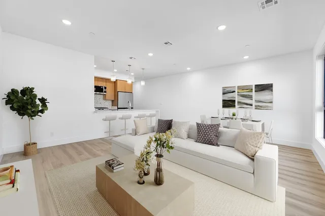 a living room with furniture and flowers