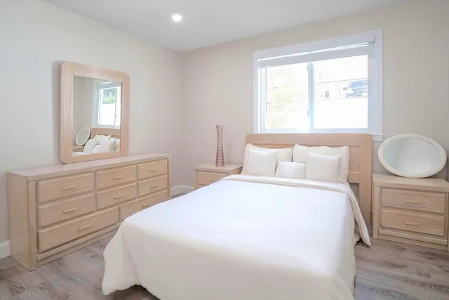 a bedroom with a bed and a closet with mirror