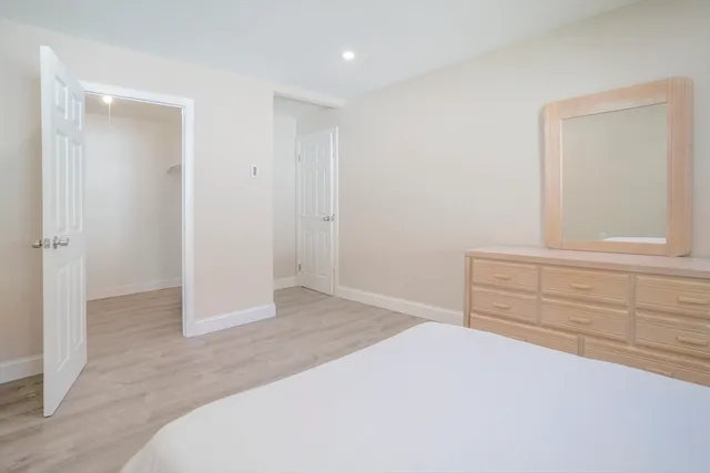 a large white bed in a white room