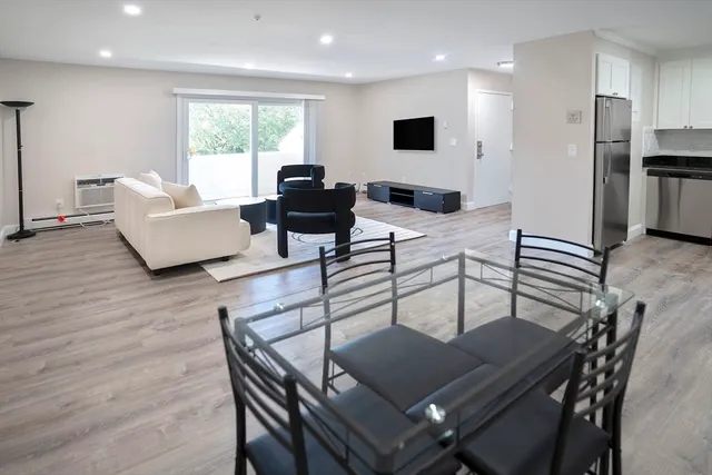 a living room with furniture a large window and a table