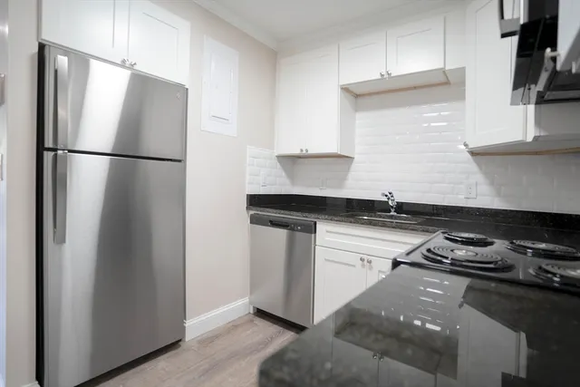 a kitchen with a refrigerator and a stove