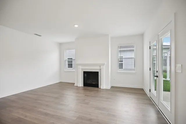 a large kitchen with stainless steel appliances kitchen island a large counter top and a wooden floors