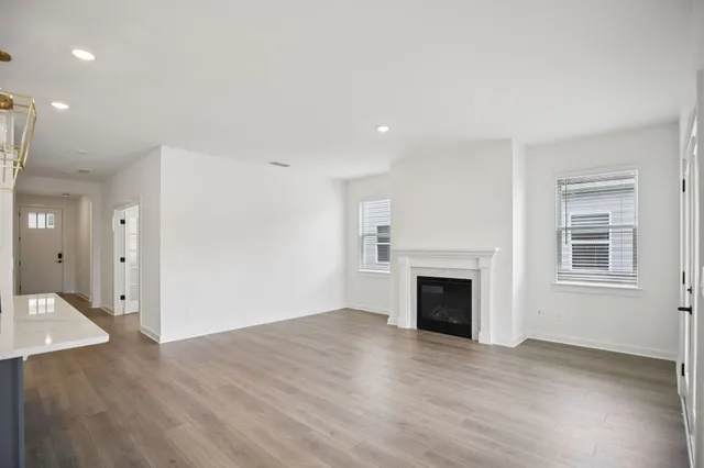 a view of an empty room with a fireplace and a window