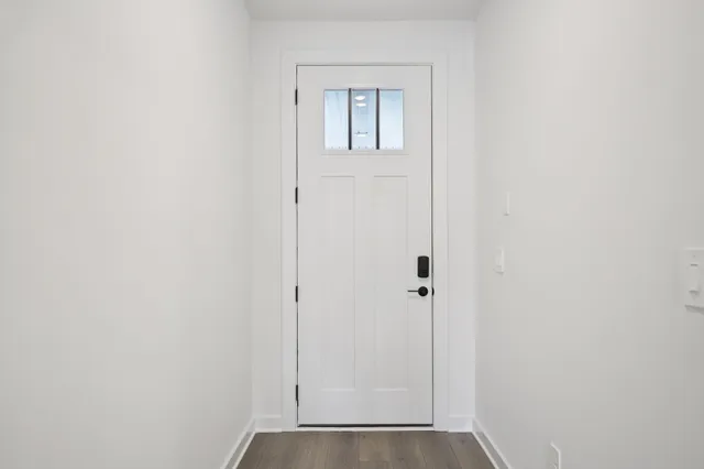 a view of a room with stairs and wooden floor