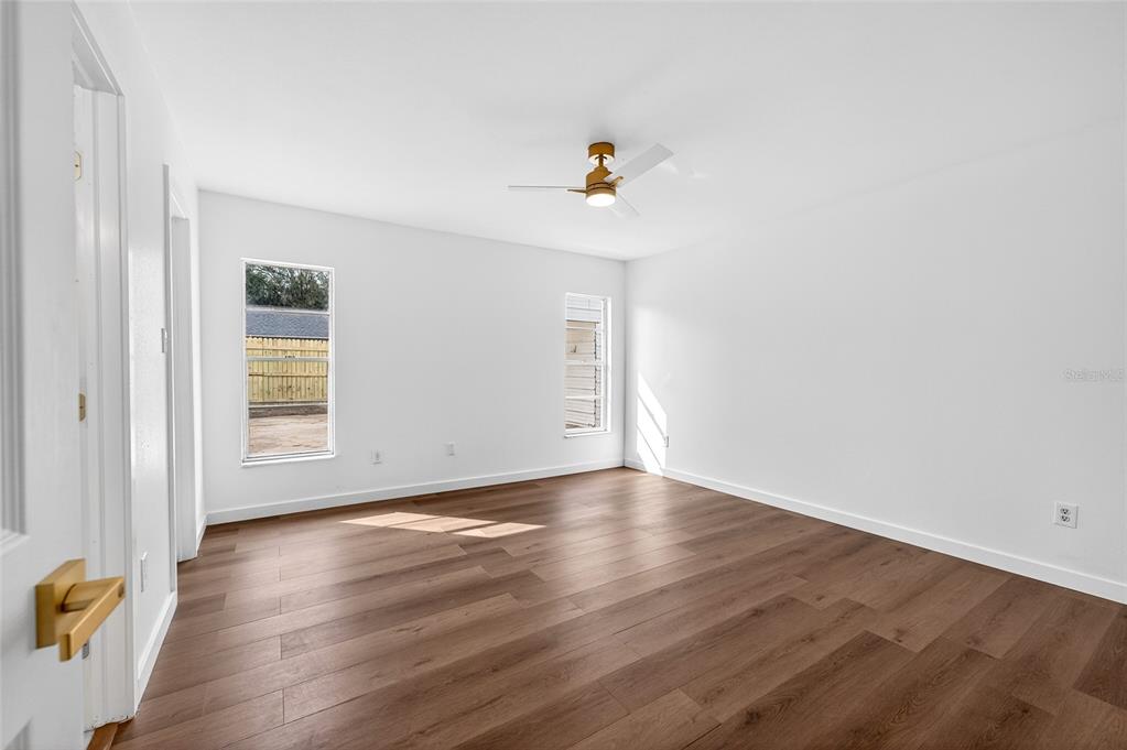 662 Bryan Terrace Drive Brandon, FL 33511 - Photo 11 of 30 a view of an empty room with wooden floor and a window