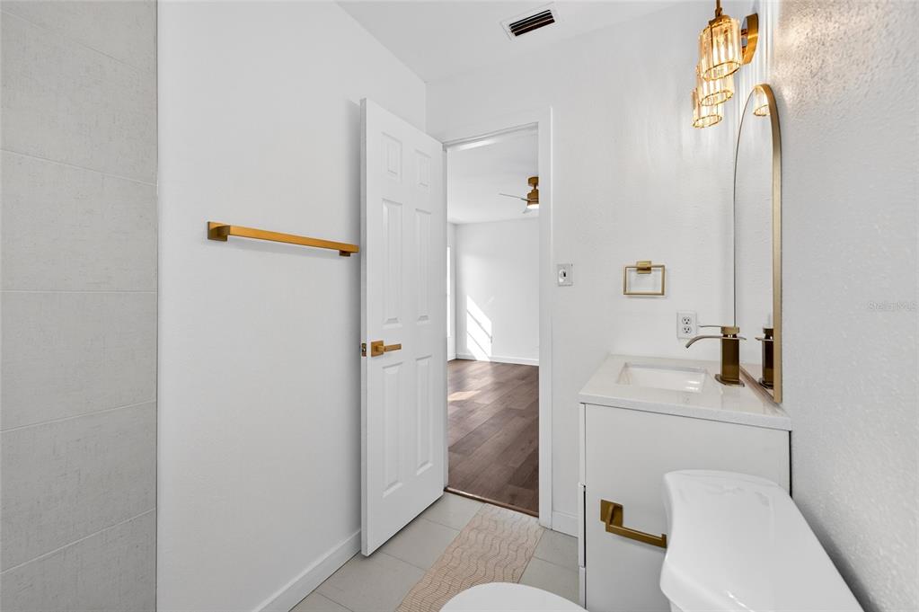 662 Bryan Terrace Drive Brandon, FL 33511 - Photo 14 of 30 a bathroom with a toilet sink and mirror