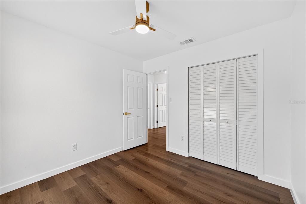 662 Bryan Terrace Drive Brandon, FL 33511 - Photo 17 of 30 a view of an empty room with wooden floor and a window