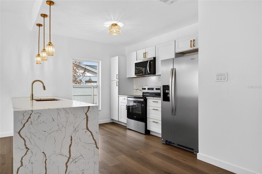 662 Bryan Terrace Drive Brandon, FL 33511 - Photo 8 of 30 a kitchen with stainless steel appliances a refrigerator and a stove top oven
