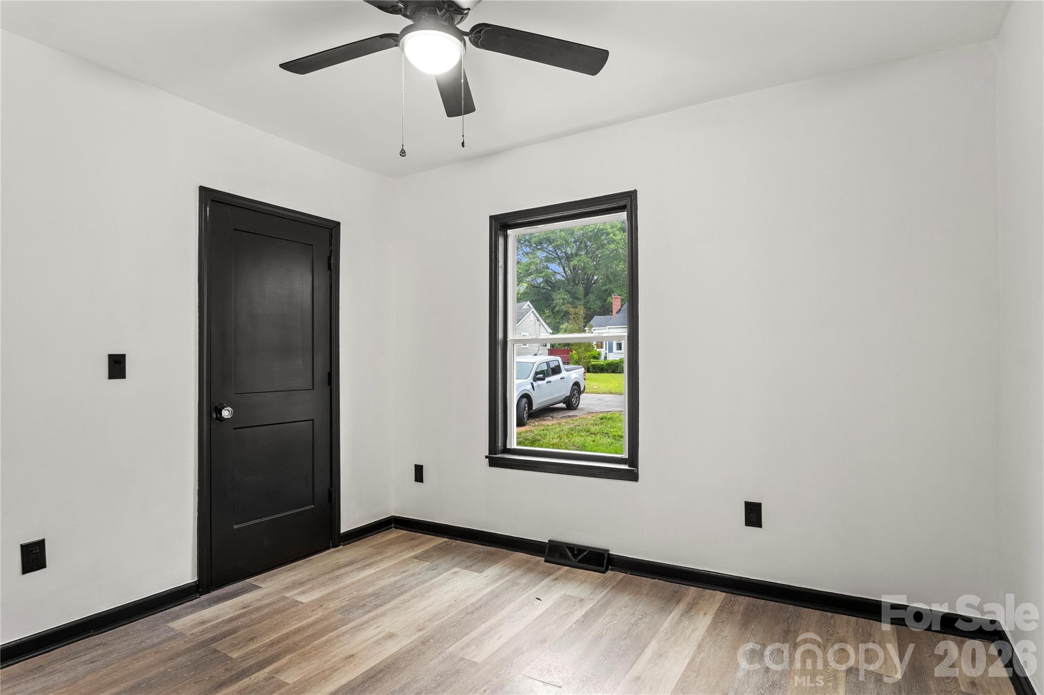 110 Courtland Street Chester, SC 29706 - Photo 9 of 22 an empty room with window and ceiling fan
