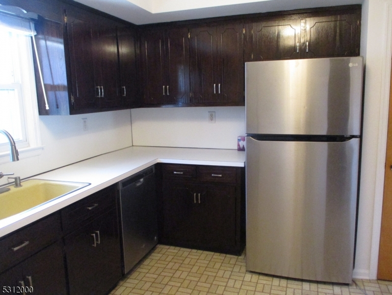 777 Springfield Avenue, Unit 17 Summit, NJ 07901 - Photo 13 of 25 a kitchen with a refrigerator and a sink