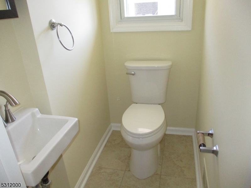 777 Springfield Avenue, Unit 17 Summit, NJ 07901 - Photo 14 of 25 a white toilet sitting next to a bathroom sink