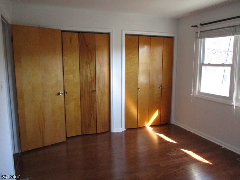 777 Springfield Avenue, Unit 17 Summit, NJ 07901 - Photo 17 of 25 an empty room with wooden floor and windows