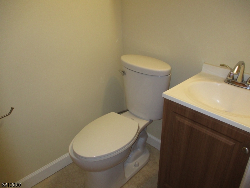 777 Springfield Avenue, Unit 17 Summit, NJ 07901 - Photo 18 of 25 a white toilet sitting next to a bathroom sink
