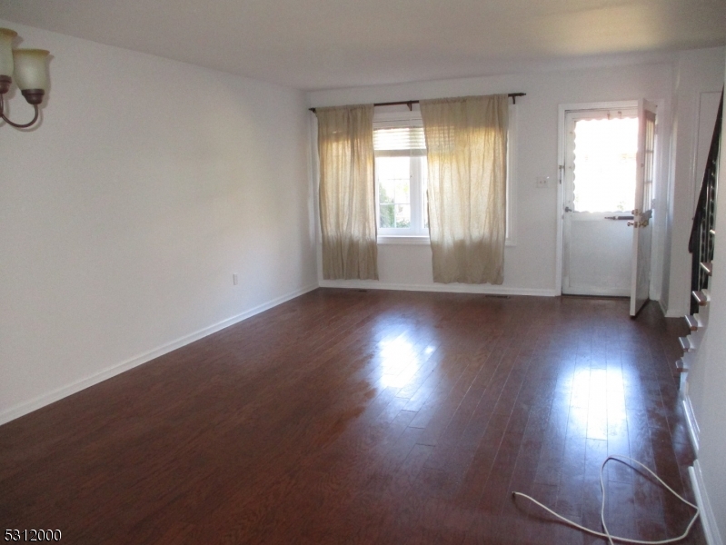 777 Springfield Avenue, Unit 17 Summit, NJ 07901 - Photo 9 of 25 an empty room with wooden floor and windows