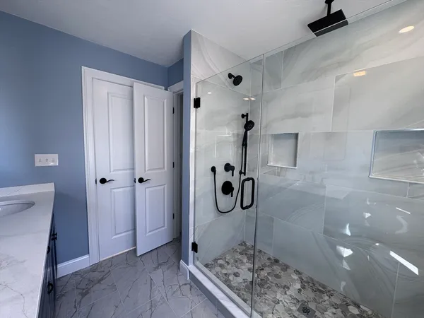 a bathroom with a glass shower door