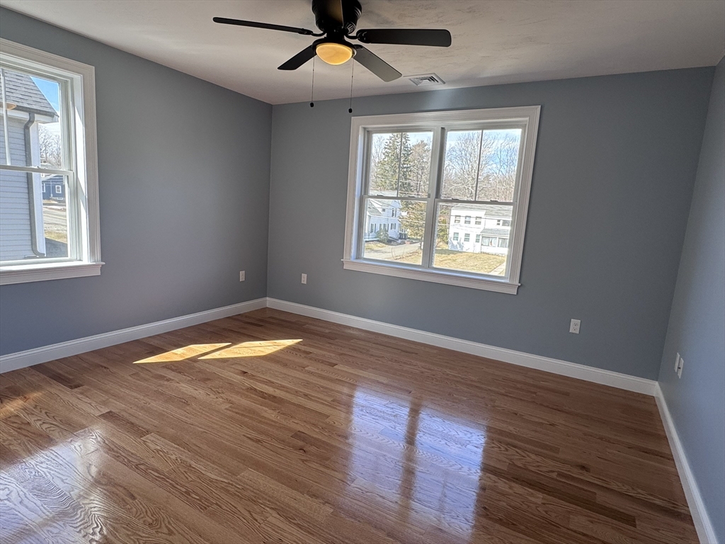 193 East Spring Street Avon, MA 02322 - Photo 14 of 27 a view of empty room with wooden floor and fan