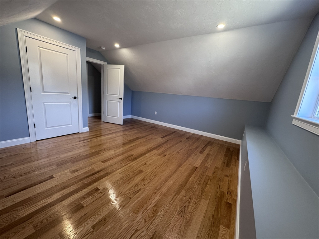 193 East Spring Street Avon, MA 02322 - Photo 19 of 27 an empty room with wooden floor and windows