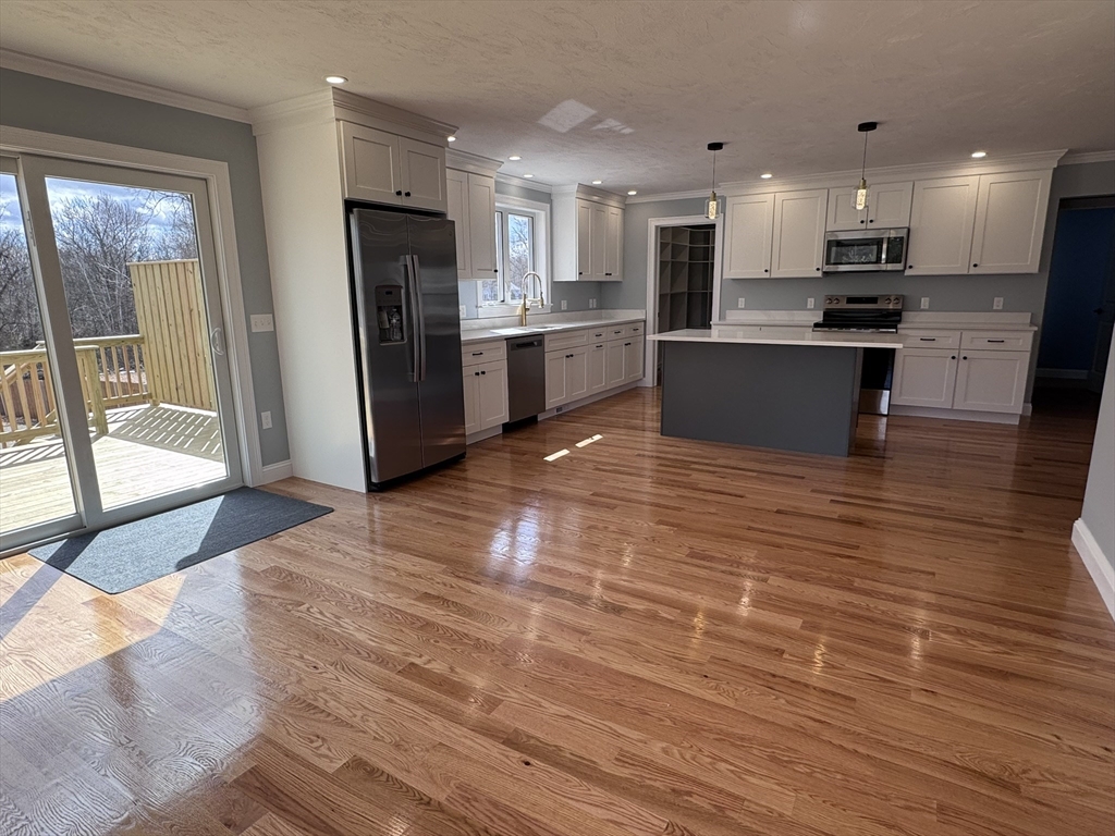 193 East Spring Street Avon, MA 02322 - Photo 5 of 27 a view of kitchen with granite countertop cabinets and refrigerator